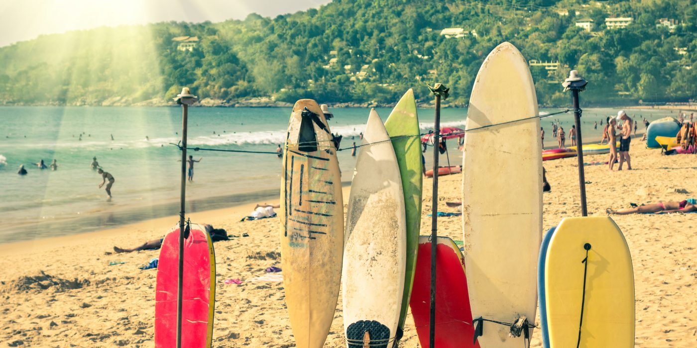 Multicolored surfboards at  Kata Beach in Phuket Island - Surf boards at tropical exclusive destination in south east Asia - Wonders of Thailand on vintage filtered look with enhanced sunshine